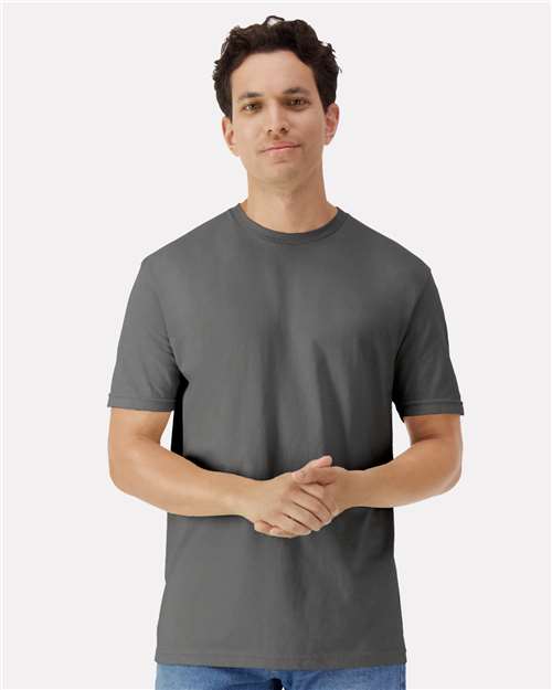 Gildan 100 white T-shirts stacked in a pile, showcasing the casual cotton shirt style.