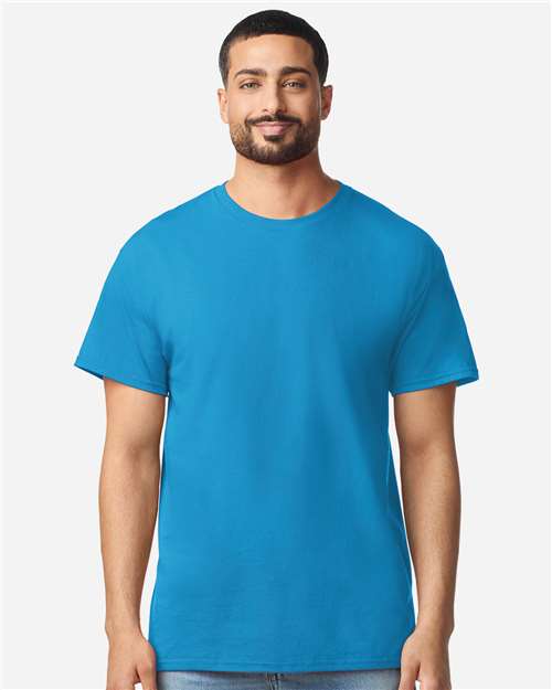 Gildan 100 white t-shirts stacked in a pile, showcasing a bulk deal offer for 100 shirts at $499