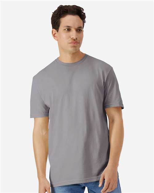 Gildan 100 plain white T-shirts arranged in a bundle, showcasing the simple, classic design of the cotton shirts.