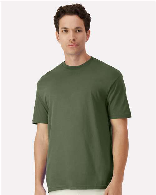 Gildan 100 white T-shirts stacked in a box, available in a limited-time deal for bulk purchase.