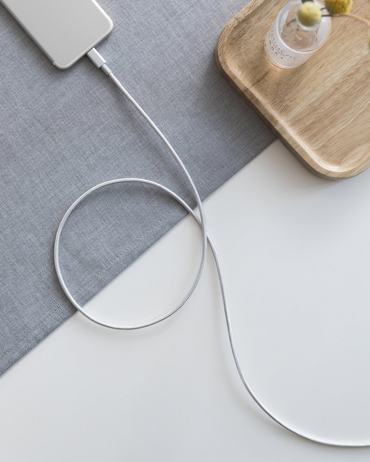 Anker 331 USB-C to Lightning charging cable shown coiled with connectors visible, designed for iPhone charging.