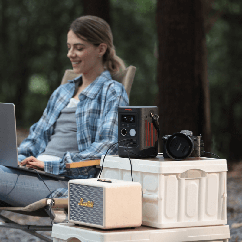 Jackery Explorer 300D portable power station with multiple ports and digital display, designed for outdoor and emergency power needs.