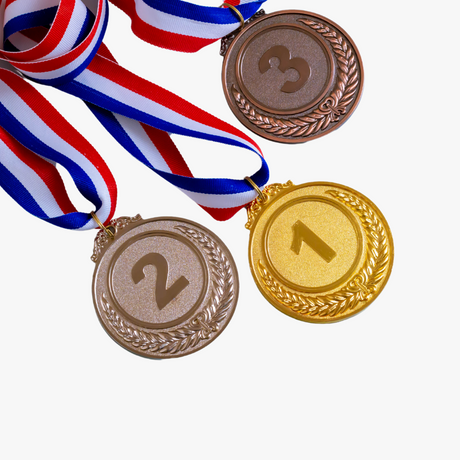 A collection of medals including Square Star, Weave, Sun, and Diamond styles in antique bronze, bright silver, and bright gold finishes, showcasing 2" insert holder options, highlighting the title Medals.