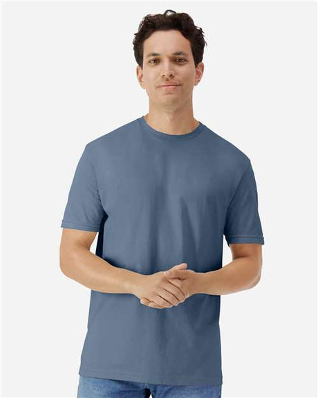 Gildan 100 white cotton T-shirts laid out flat, with a focus on fabric texture and classic crew neck style.