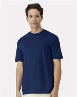 Gildan 100 white T-shirts laid out flat, showcasing soft cotton fabric and classic crew neck design.