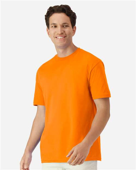 Gildan 100 white T-shirts stacked together, plain cotton shirts perfect for bulk purchase, shown in a retail display image.
