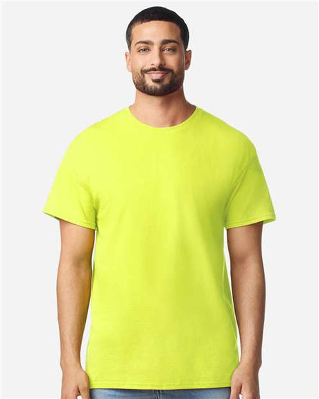 Gildan 100 plain T-shirts in various colors, displayed in a pile, available in a limited-time deal for bulk purchase.