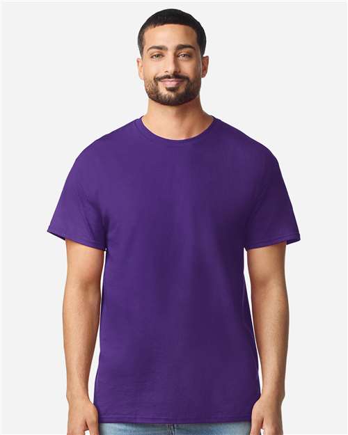 Gildan 100 plain white T-shirts displayed in a bundle, showing soft cotton fabric and classic crew neck design.