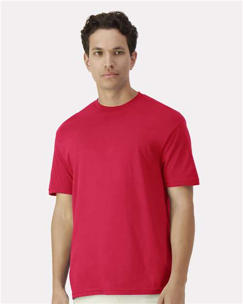 Gildan 100 white T-shirts displayed in a bundle, showing a variety of plain cotton shirts for a bulk clothing deal.