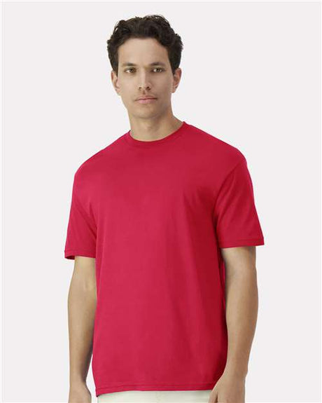 Gildan 100 white T-shirts displayed in a bundle, showing a variety of plain cotton shirts for a bulk clothing deal.