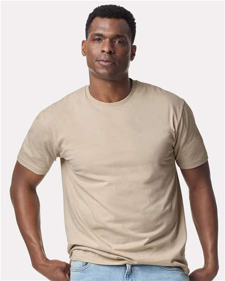 Gildan 100 plain white T-shirts displayed in a group, showcasing soft cotton fabric and classic crew neck style.