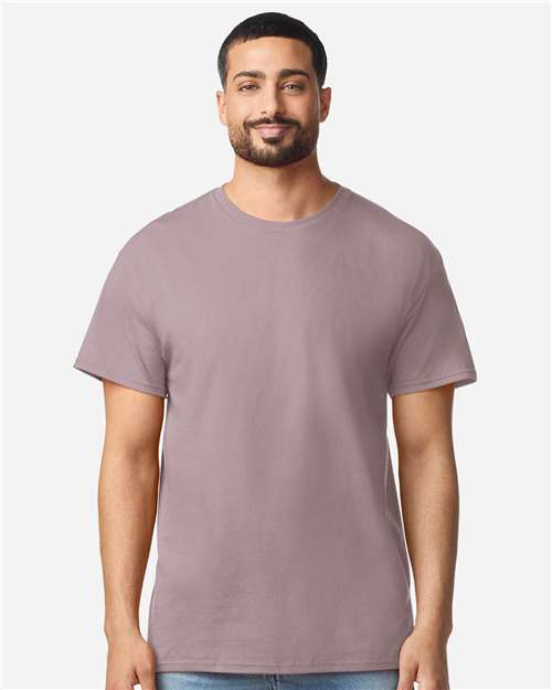Gildan 100 plain white T-shirts laid flat, showcasing soft cotton fabric and classic crew neck design.