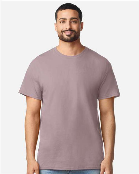 Gildan 100 plain white T-shirts laid flat, showcasing soft cotton fabric and classic crew neck design.