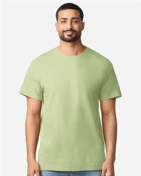 Gildan 100 plain white T-shirts stacked on a table, promotional image for limited time deal on bulk T-shirt purchase.