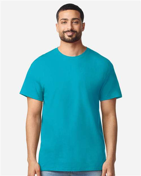 Gildan 100 plain white T-shirts stacked neatly, displayed as part of a limited time deal offer.