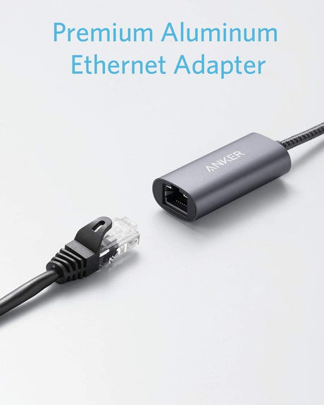 Anker PowerExpand USB-C to Gigabit Ethernet Adapter connected to a laptop, showing Ethernet port and cable connection.