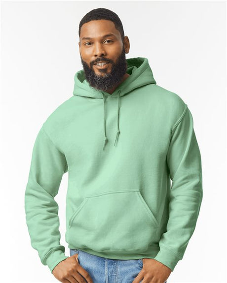 Unisex Heavy Blend™ Gildan hoodie with a front pocket and drawstrings, shown in a neutral color, casual and comfortable fit.