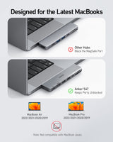 Anker 547 USB-C Hub for MacBook with multiple ports, charging only, compact design, black, connected to a MacBook.