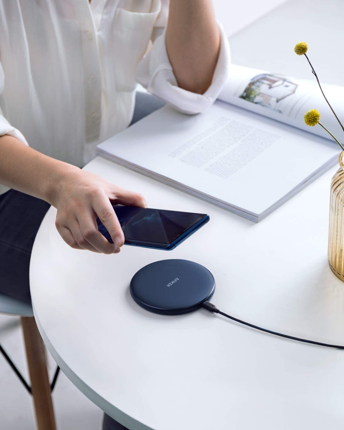 Anker 313 wireless charging pad for charging smartphones and devices, black flat pad with charging indicator light.