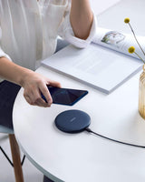 Anker 313 wireless charging pad for charging smartphones and devices, black flat pad with charging indicator light.