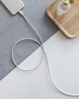 Anker 331 USB-C to Lightning charging cable shown coiled with connectors visible, designed for iPhone charging.