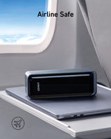 Anker Prime 27,650mAh power bank and 100W charging base, compact black charging device with ports and power indicators.