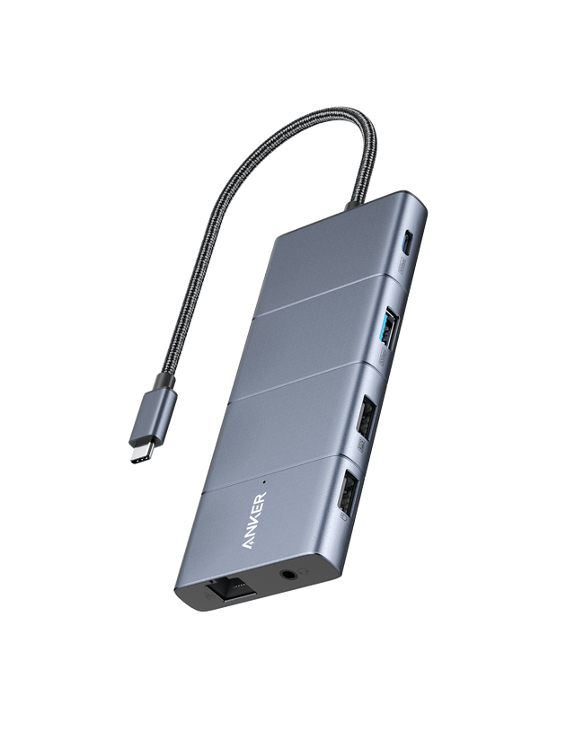 Anker 565 USB-C Hub charging only with multiple ports, compact design, and sleek black finish, shown connected to a laptop.