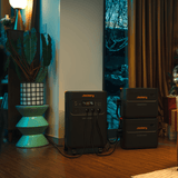 Jackery Battery Pack 5000 Plus attached to a stylish handbag, showing portable power source integrated with fashion accessory.