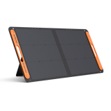 Jackery SolarSaga 100W solar panel add-on showing portable black solar panel with adjustable stand and foldable design.