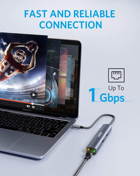 Anker 543 USB-C Hub 6-in-1 slim charging station with multiple ports, shown connected to a laptop.