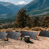 Jackery SolarSaga 200W solar panel outdoors, folded with visible solar cells and sturdy handle for portable solar power.